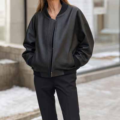 Elmswell Faux Leather Bomber in black worn with black trousers, front view