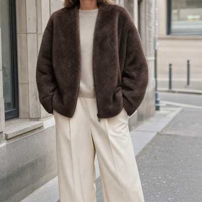 Norwood Teddy Fleece Jacket in chocolate brown worn with cream trousers, front view